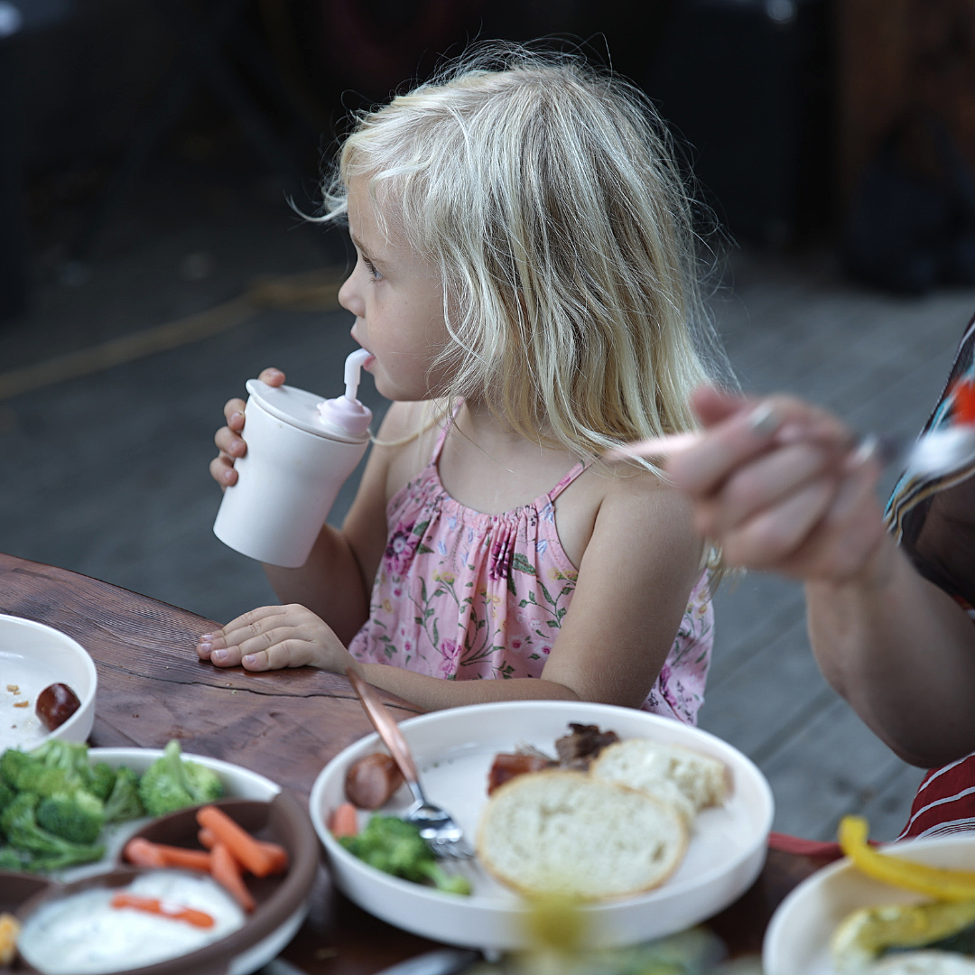 Healthy Picnic Food for Kids image of child eating at a picnic