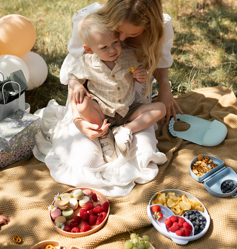 Mom with child in a a picnic setting with miniware products 